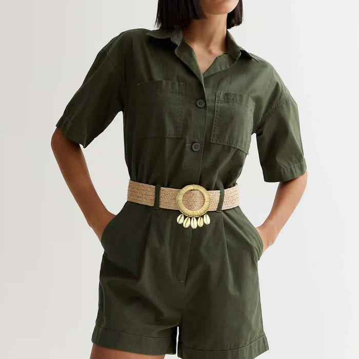 Ani Accessories Beige Circle Raffia hanging shell buckle belt on a model wearing with a olive green shorts jumpsuit.
