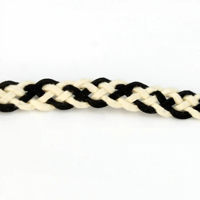 Ani Accessories suede belt. This braided belt is crafted from black and white suede, showcasing detailed braiding on a white background.