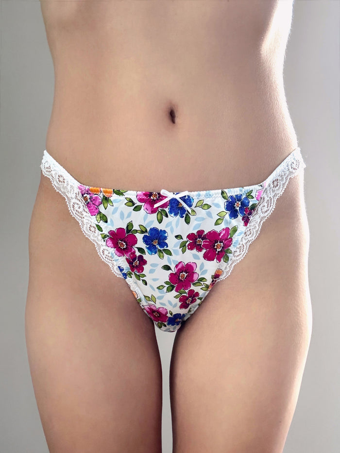 Back view of floral panties with scalloped lace waistband, white with bouquet print
