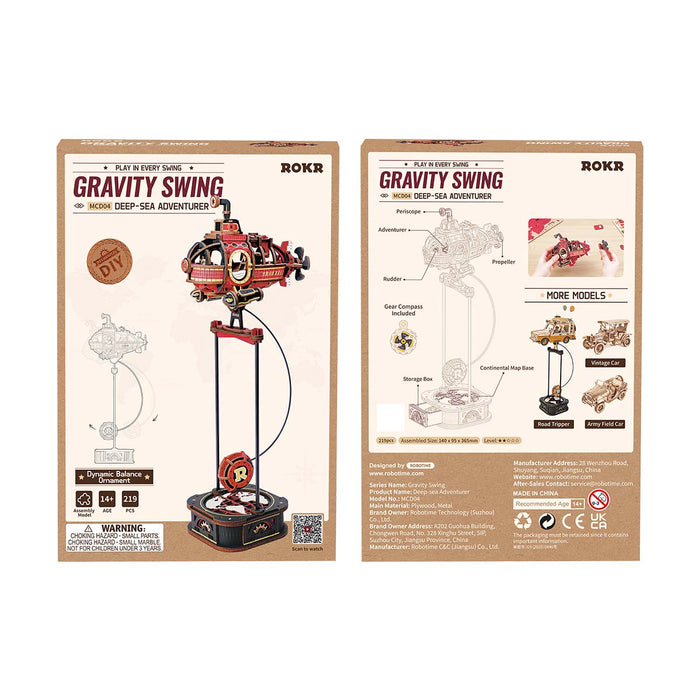 ROKR Deep-Sea Adventurer Gravity Swing MCD04 and ROKR Road Tripper MCD03 side-by-side lifestyle display on oak desk with framed prints and guitar ornament