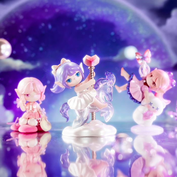 Rolife Suri's Colorful Girls SKXX three collectible surprise figures displayed together including a white unicorn rider, a pink sitting elf and a floating pink girl on purple starry backdrop