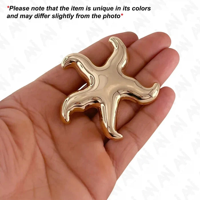 Ani Accessories Gold Starfish Metal Buckle on the palm with caution text of product may be differ slightly from the image in a white background.