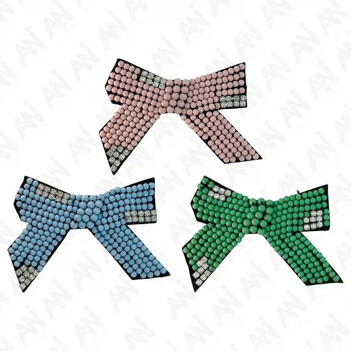 Three colorful beaded bows  patch on a white background