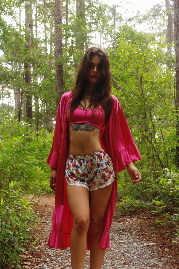 Long pink satin robe with tie belt and flared ruffle sleeves, open front