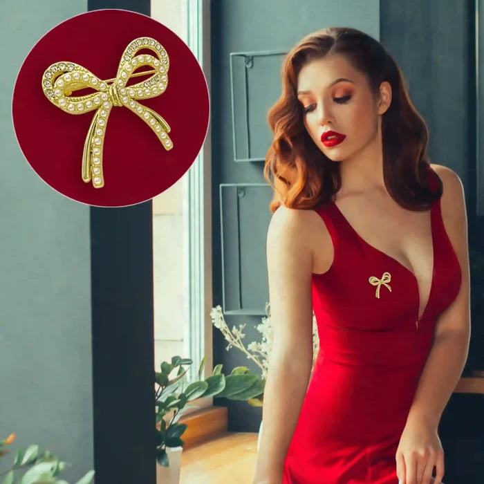 Gold Bow Pearl Rhinestone Brooch for Women's Fashion attached to a red dress for stylish elegance