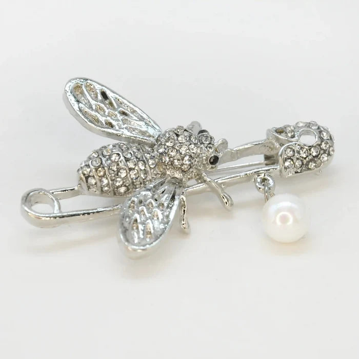 Ani Accessories close photo of silver honey bee rhinestone safety pin brooch on white background for fashion accessories.