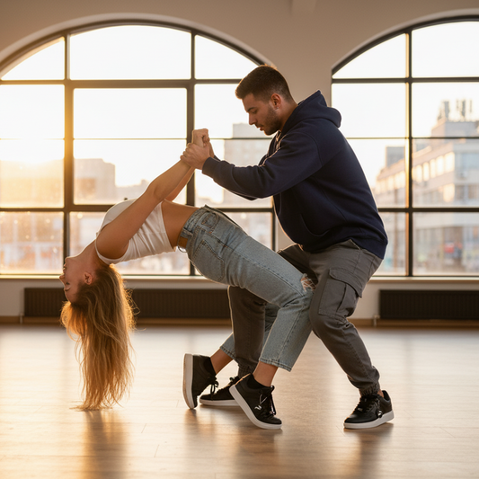 Dancer performing a lift in a dance studio with large windows.