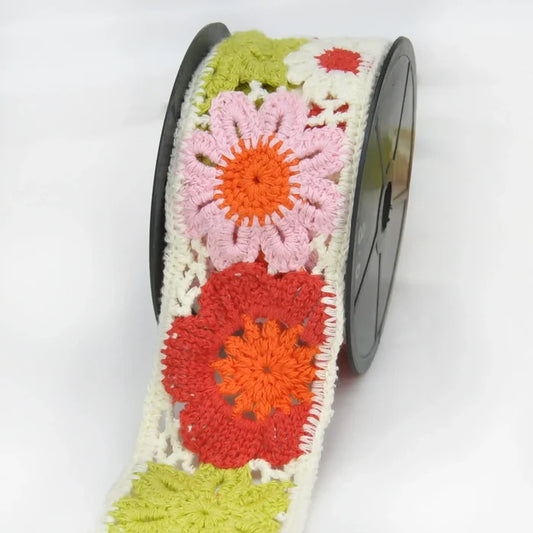 Colorful crochet lace with floral patterns  on lace roll in a white background