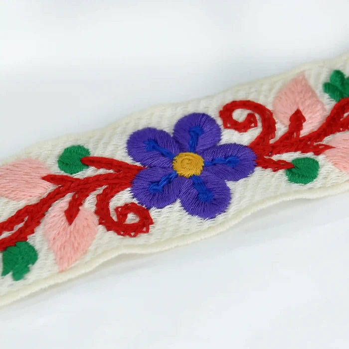 Extreme zooming image of Embroidered floral design crochet with a purple flower on a white background | Ani Accessories