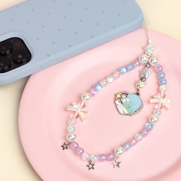 Rolife Nanci Sweet Time Hidden Honey Air lanyard coiled on a pink plate beside a blue phone case, showing iridescent pearl beads and illustrated enamel charm.