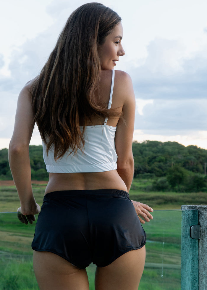 Midnight black shortie shorts with flared skirt-like hem and ruched waist