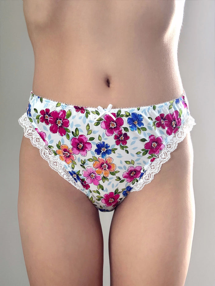 Floral lace panties with multicolor bouquet print, lace trim, and bow at waist