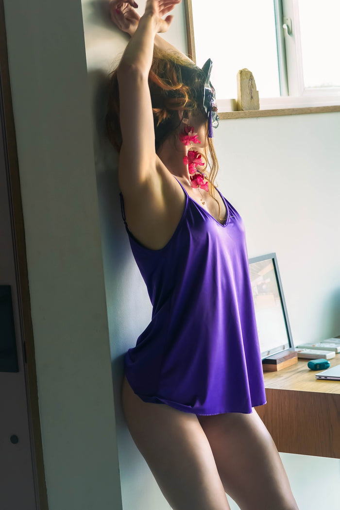 Violet satin nightie romper with scoop neckline, thin straps, and flared hem