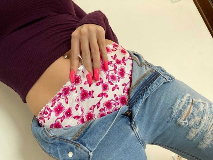 Pink floral panties bunched on top of fabric