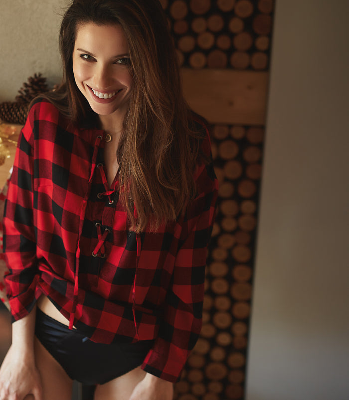 Black lace-trim panties shown at the waist under a red plaid top