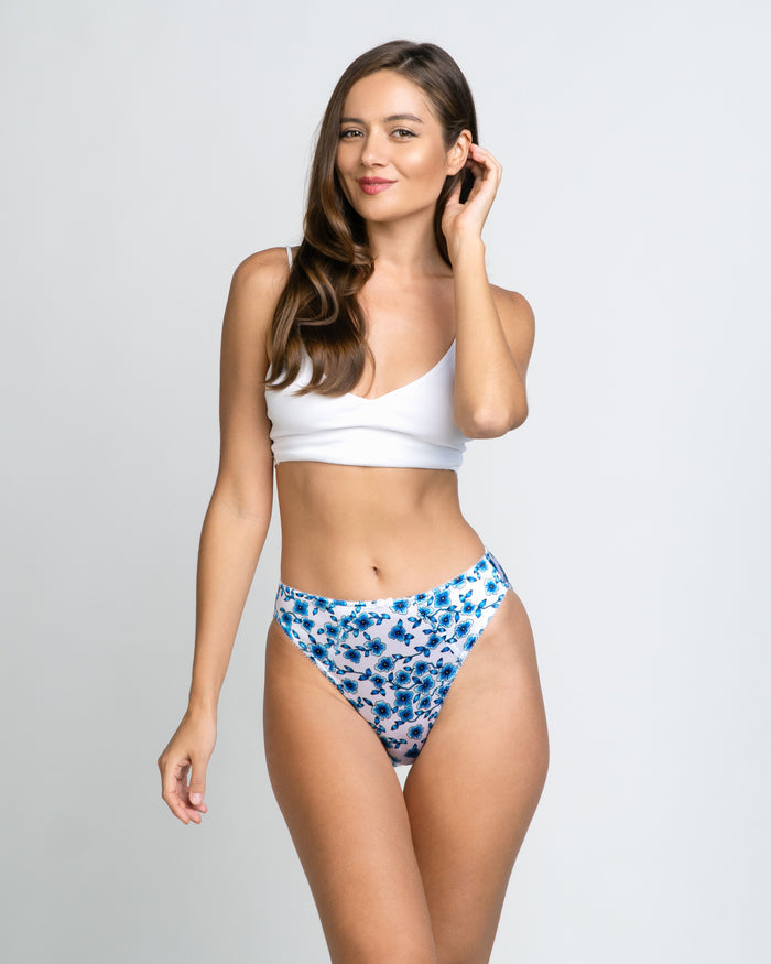 Women’s blue floral thong-style panties with picot elastic along the leg openings.