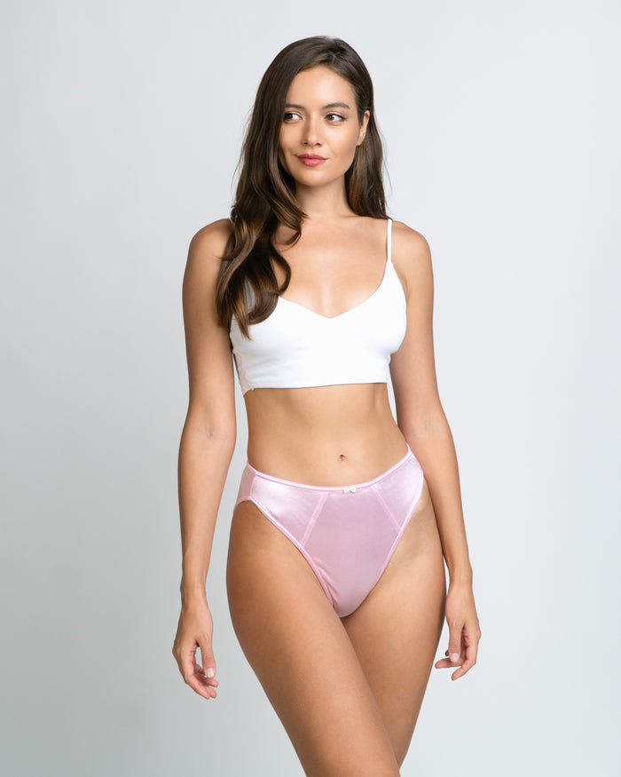 Soft pink satin panties with lace trim, front view on model