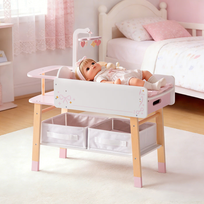 ROBUD wooden doll changing table in pink and white, shown alone in a cozy bedroom setting with storage baskets.