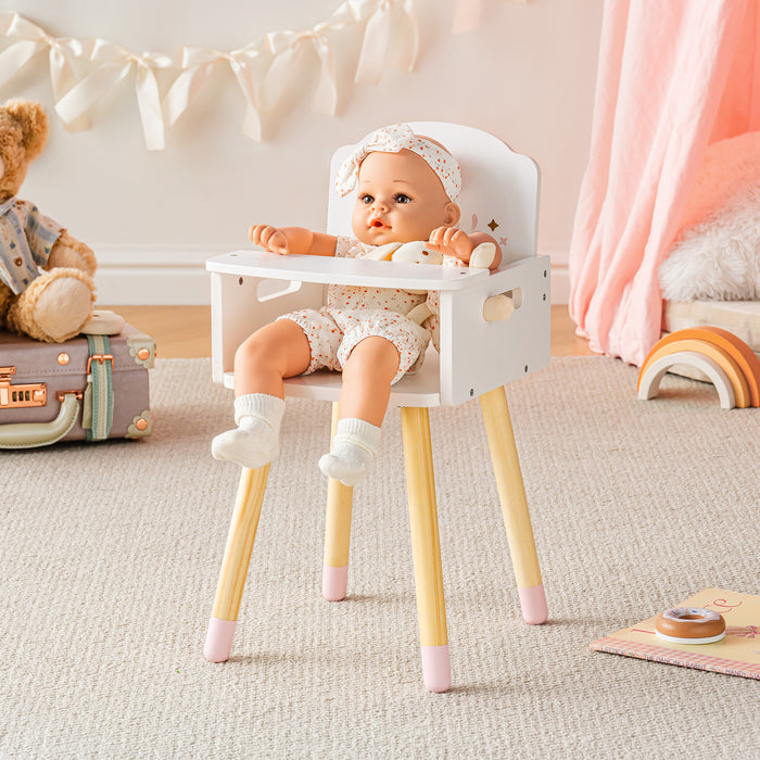 Baby doll in bonnet seated alone in the ROBUD white doll high chair with pink accents on a neutral beige rug.