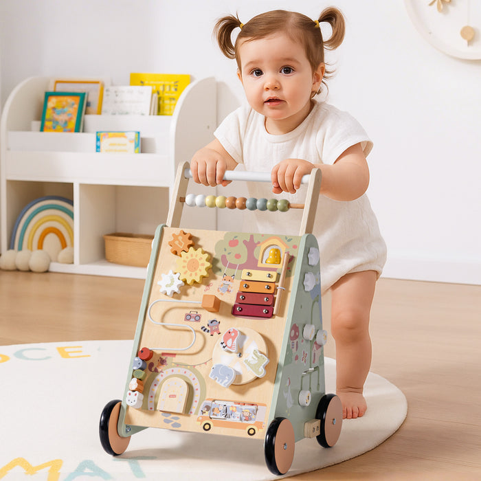 ROBUD Forest Fairy Baby Push Walker with toddler girl pushing the sage green forest-themed wooden walker across light wood flooring in bright playroom