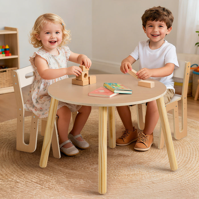 Two young children laugh while stacking colorful blocks together at the ROBUD natural wood round table and chair set.