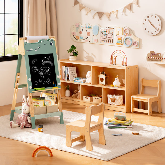 ROBUD green dino easel with chalk art wooden bookshelf and small chair arranged in a warm toned kids bedroom.