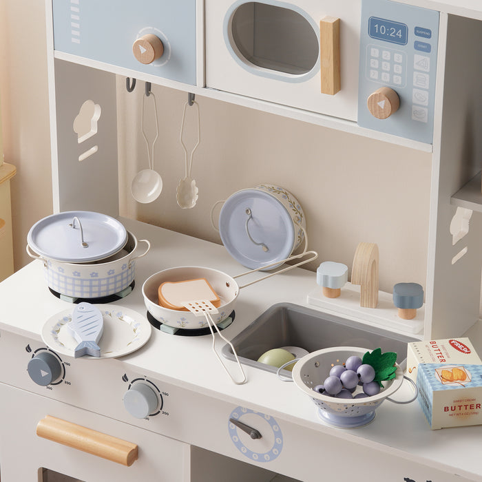 Close-up of the ROBUD white wooden play kitchen counter showing a rice cooker, colander with toy grapes, and pantry box.