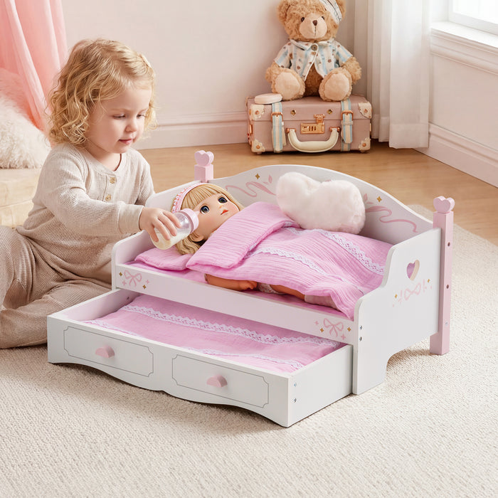 Toddler girl placing baby doll into ROBUD white and pink wooden doll sofa bed with pink quilt in a soft pink bedroom setting