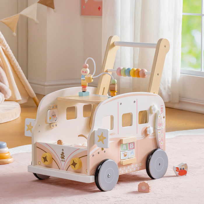 ROBUD pink vacation bus push walker side profile showing the bus shaped body with colourful activity beads on top.