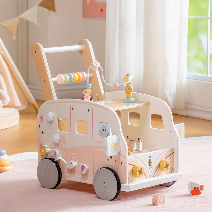 ROBUD pink wooden bus baby walker with bead abacus displayed in a softly lit playroom with pastel decor.