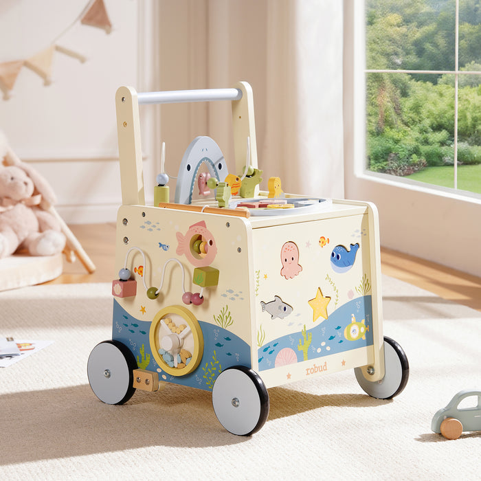 ROBUD Wooden Baby Push Walker Underwater World hero front view in bright nursery showing full ocean-themed white walker with rubber wheels on light wood floor