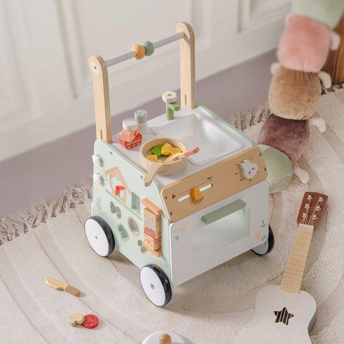 ROBUD Spring Countryside green wooden baby push walker showing side panel with food-themed activity features including clock, shape sorter and stacking blocks