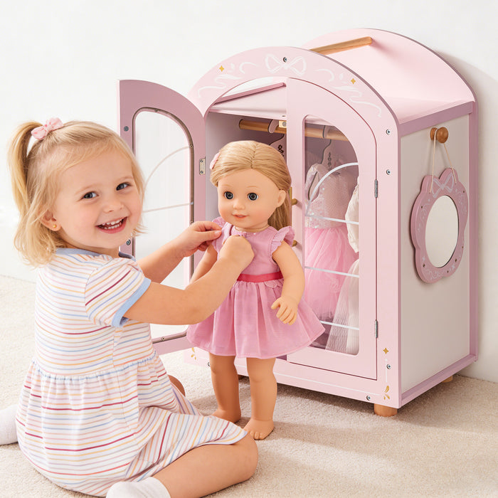 Young girl smiles as she places a doll into the ROBUD pink arched wardrobe in a pastel styled bedroom.