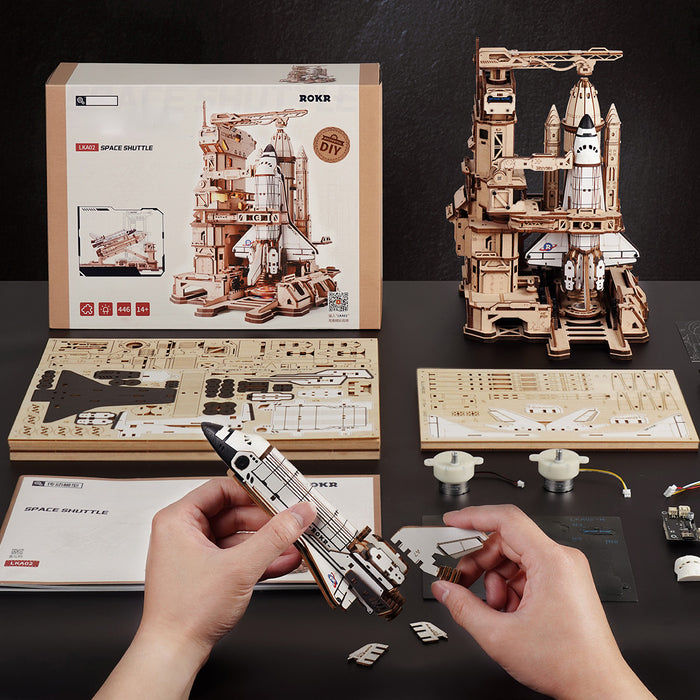 ROKR Space Shuttle LKA02 wooden puzzle retail box showing front and back with diagram labels, assembled dimensions of 249 by 196 by 272 mm, and other model suggestions