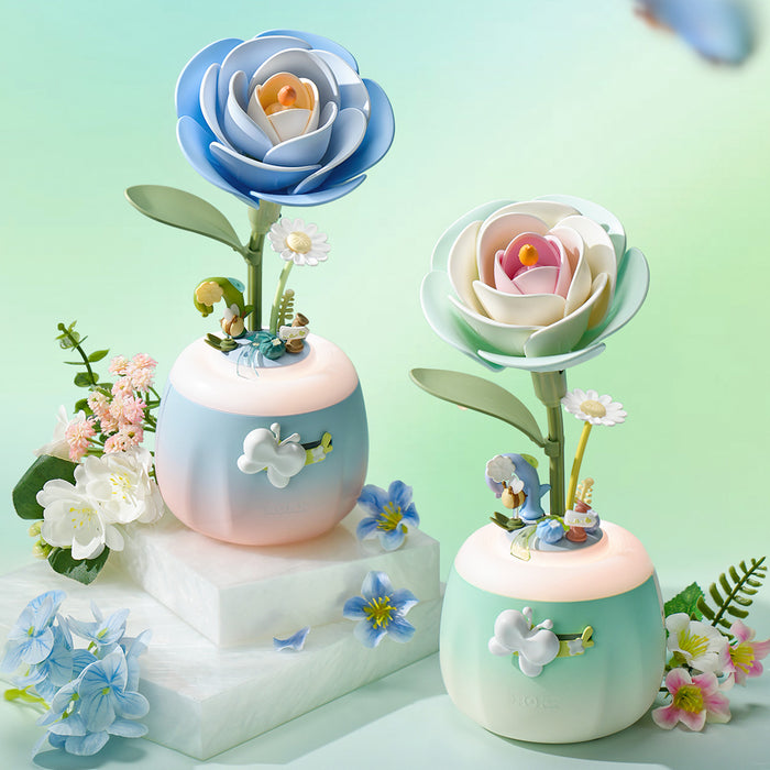 ROKR Starry and Minty Camellia Lamps displayed together among fresh blue and pink flowers on marble blocks in a botanical lifestyle scene