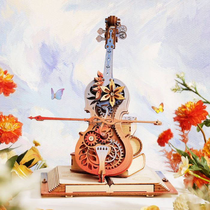 ROKR Symphony of Gorgeous Dreams AMK63M cello music box full view surrounded by orange flowers against a soft watercolor painted garden background