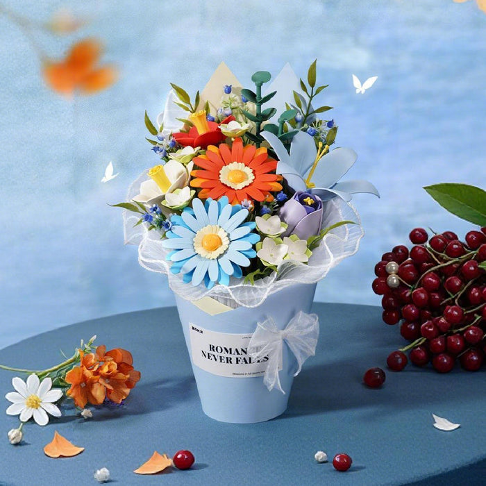 Rolife Romance Never Fades mini flower bouquet in white pot with blue daisies, orange flowers and red berries on soft blue backdrop
