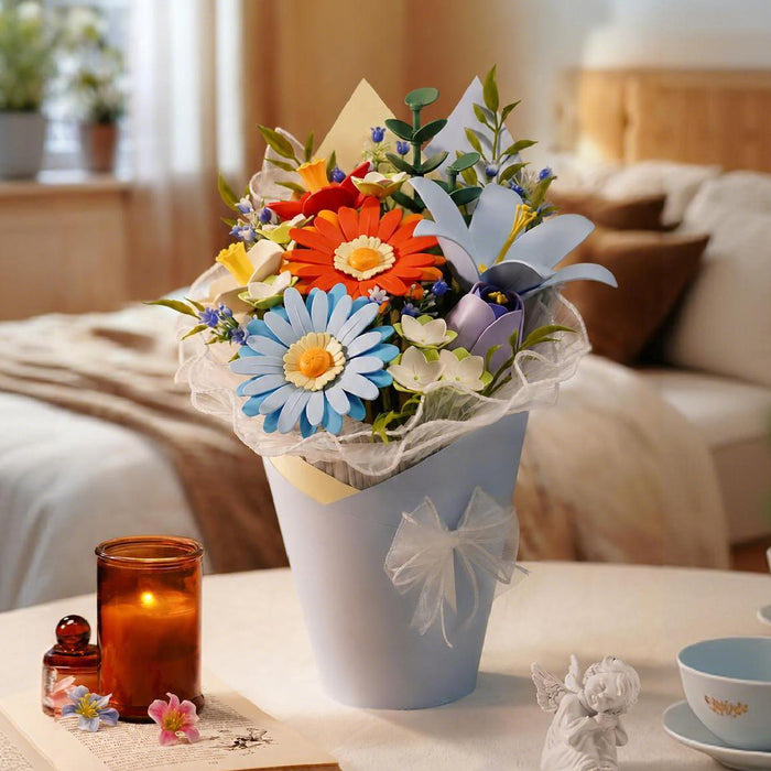 Rowood foam bouquet of orange gerberas and blue daisies in a white pot on a bedroom table with candlelight