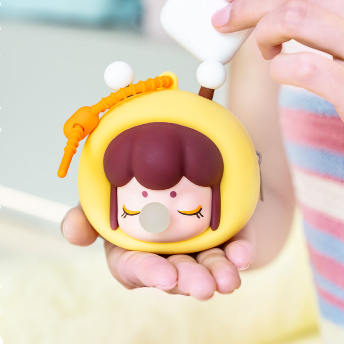 Rolife Baby Nanci Fluffy Party Headphone Case Bee variant close-up showing yellow rounded body, bee antenna topper, and orange braided phone strap