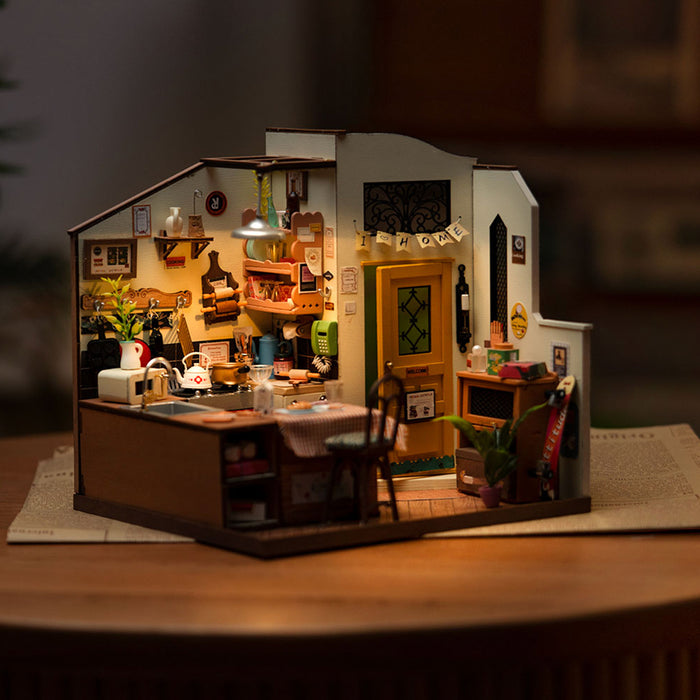 Rolife Cozy Kitchen DIY miniature house fully assembled with warm interior lighting showing tiny counters and appliances