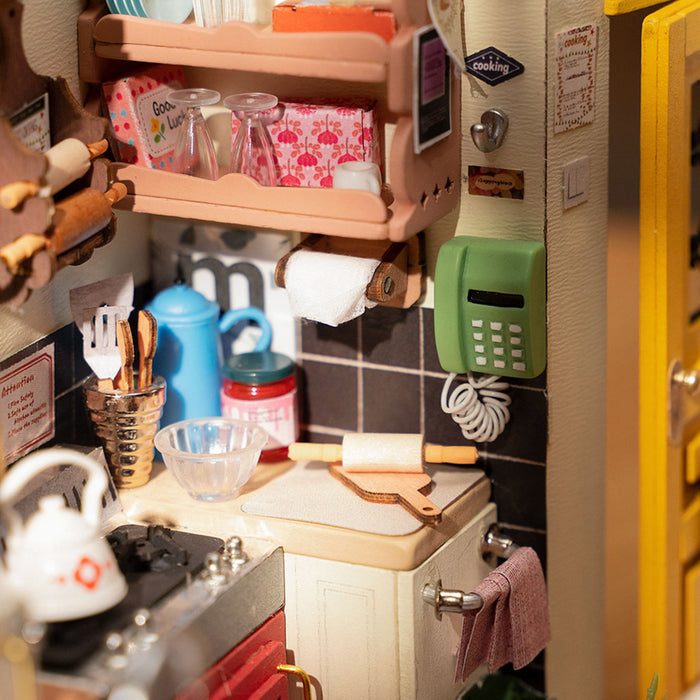 Rolife Cozy Kitchen miniature interior close-up showing a tiny fridge, wall shelves, utensils and colorful kitchen details