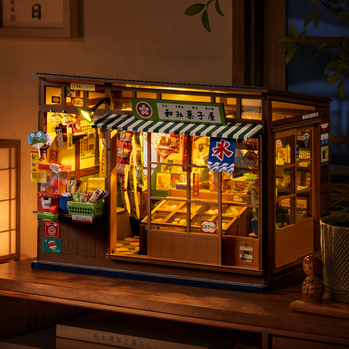 Illuminated Rolife Nostalgic Corner Shop displayed on a dark wooden cabinet