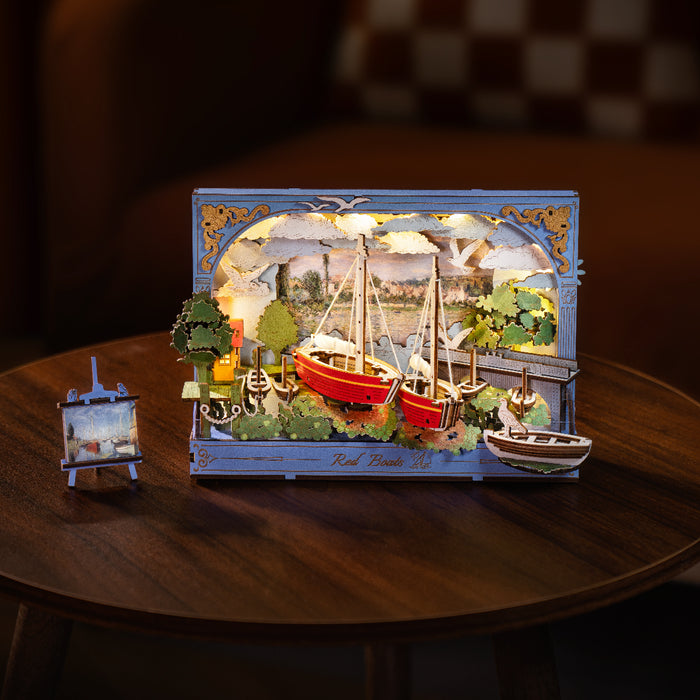 Rolife Red Boats 3D art frame with warm glowing LED lighting on a round table in a dimly lit room