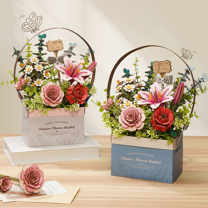 Two Rowood Dahlia Flower Basket wooden bouquets side by side on a white surface showing pink and blue gift box packaging
