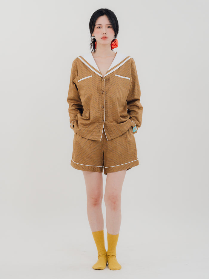 Front view Woman wearing PEKGEE Sailorette Golden Hour handmade premium cotton pyjama set.