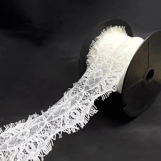 A roll of Scalloped Edge Eyelash Lace in white, perfect for crafting and decoration projects.