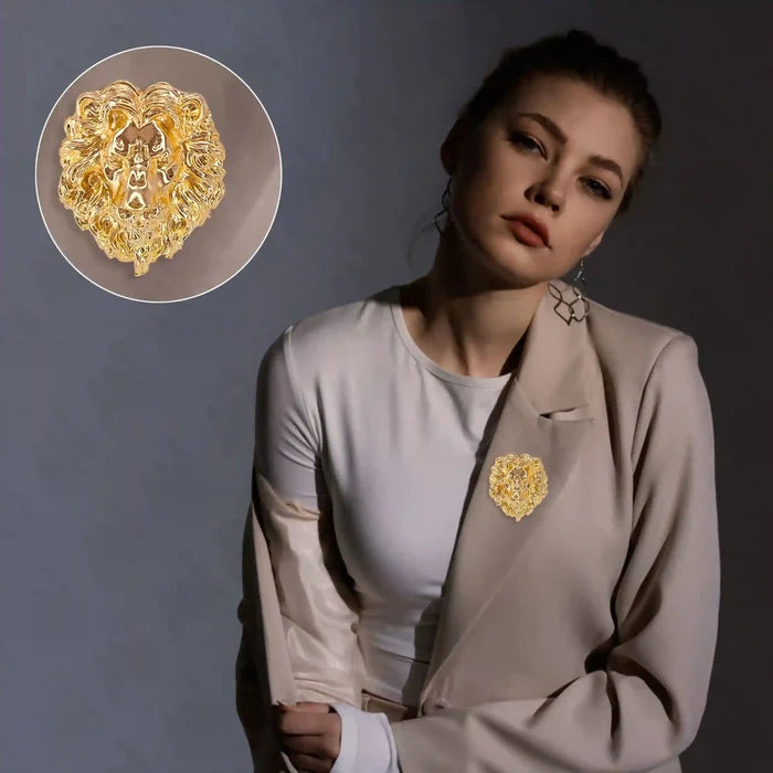 Elegant gold lion brooch worn on a model's blazer, showcasing intricate detailing and bold design