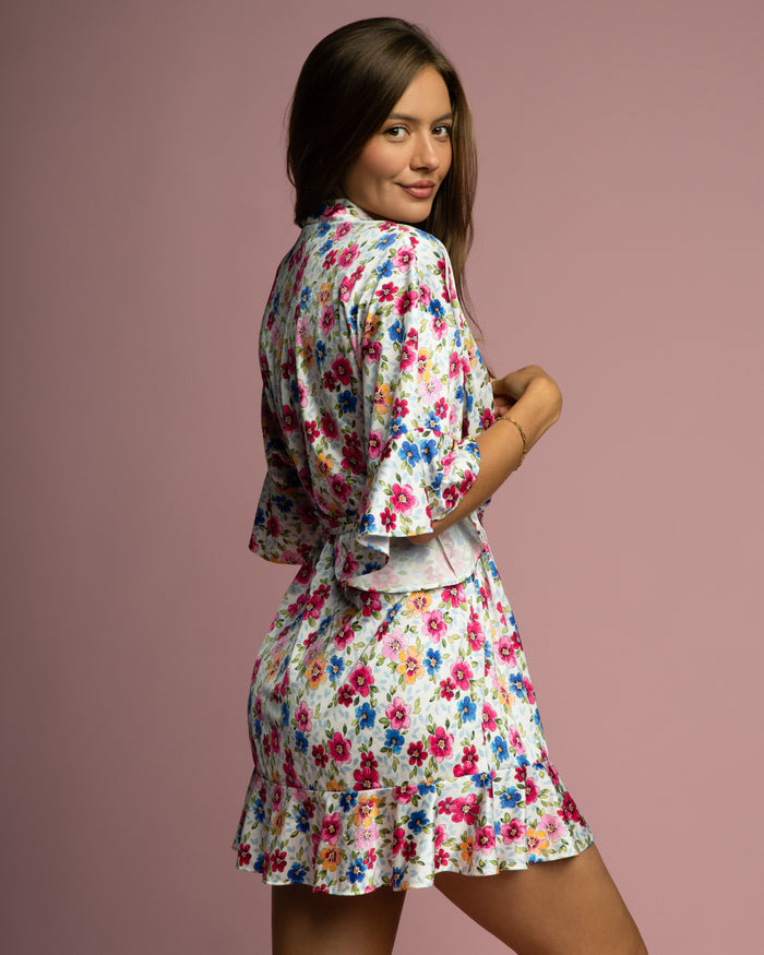 Floral robe in multicolor blooms with tie belt, layered skirt, and ruffled sleeve hem.