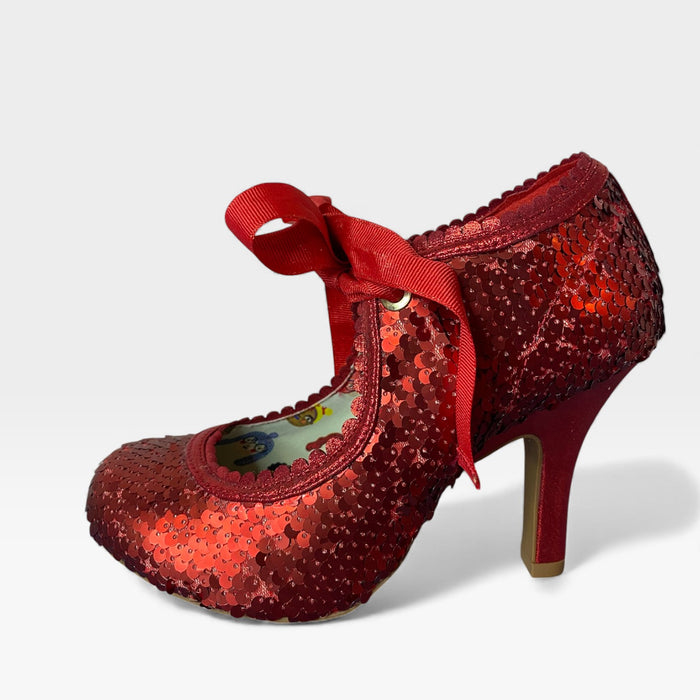 Red glittery shoe with a bow on a light gray background