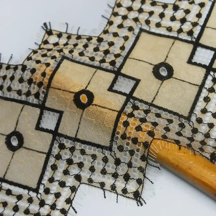 Elegant black and gold patterned fabric by Ani Accessories with intricate designs and sheer texture